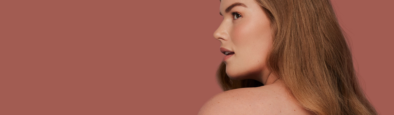 Woman looking over her shoulder with smooth skin